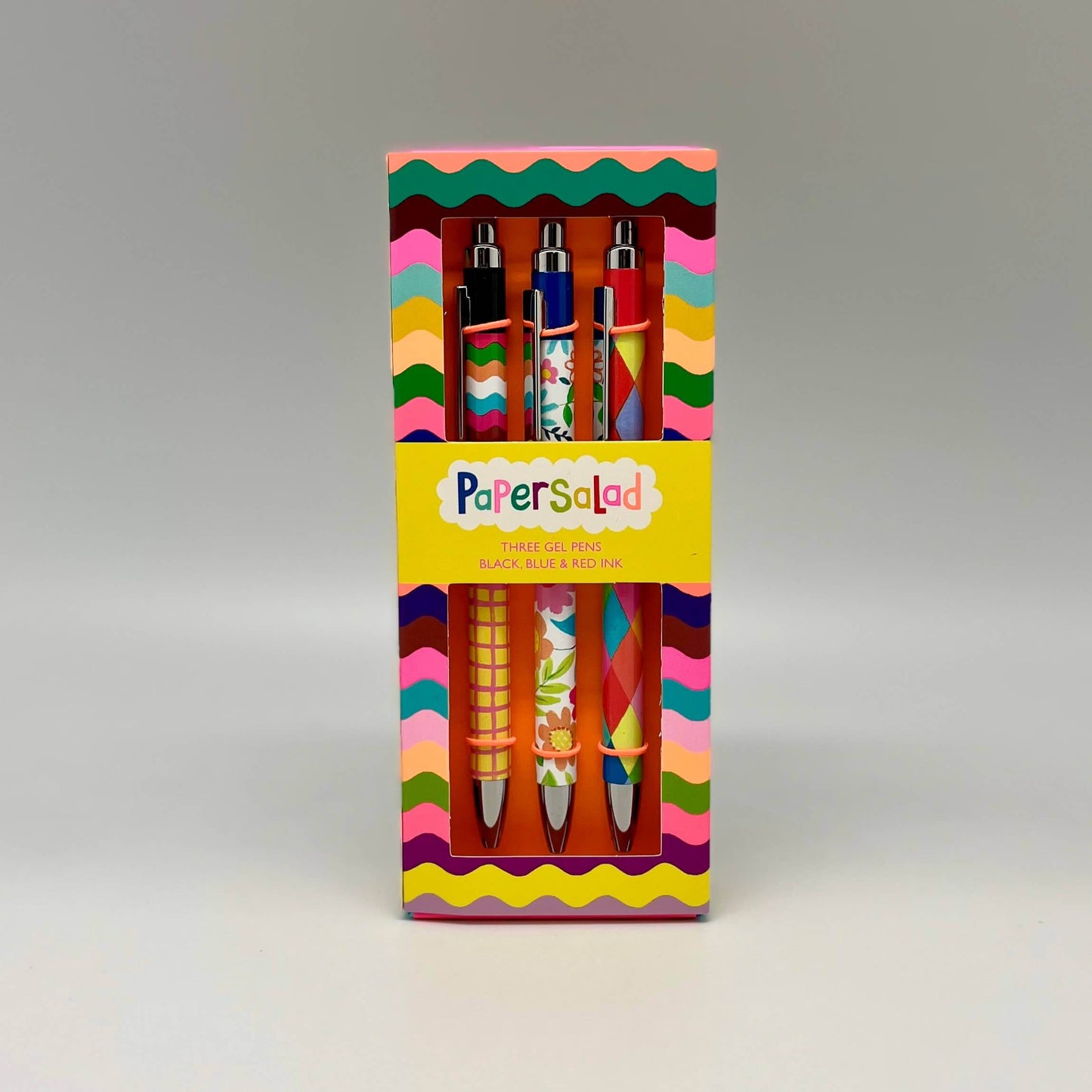 Colorful packaging of 'Papersold' pens with wavy pattern on a gray background