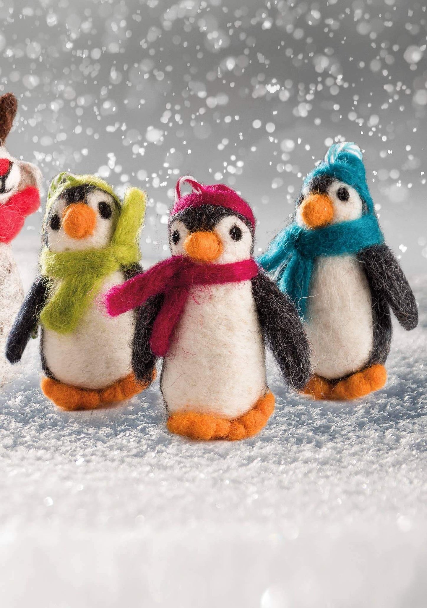 Felt Penguin Christmas Decoration - handmade felt penguins in colorful scarves on a snowy background.