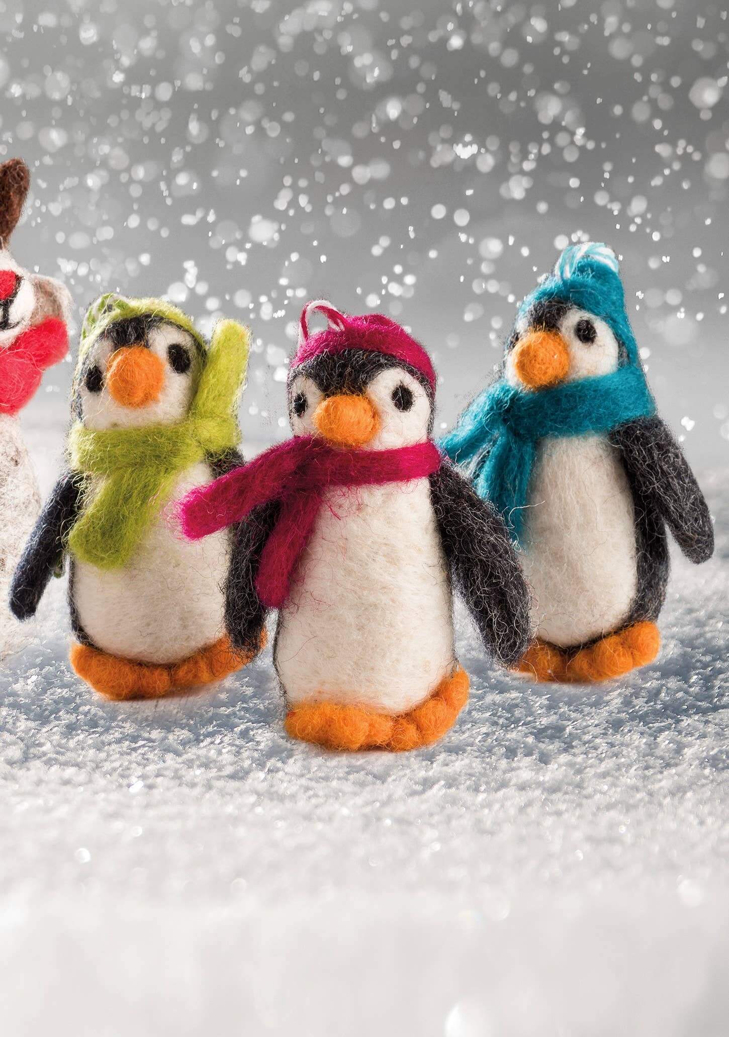Felt Penguin Christmas Decoration - handmade felt penguins in colorful scarves on a snowy background.