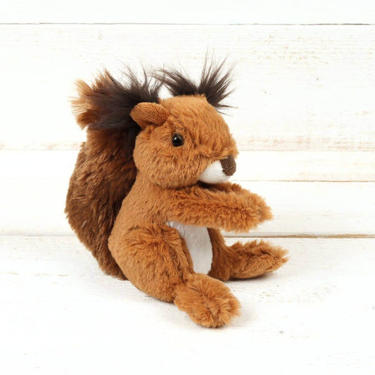 Plush squirrel toy on a light wooden background