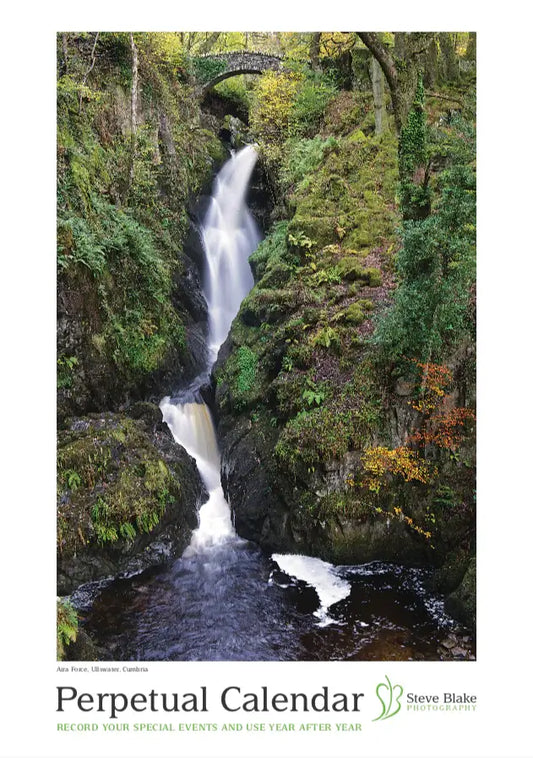 Perpetual calendar with a scenic waterfall image on a white background