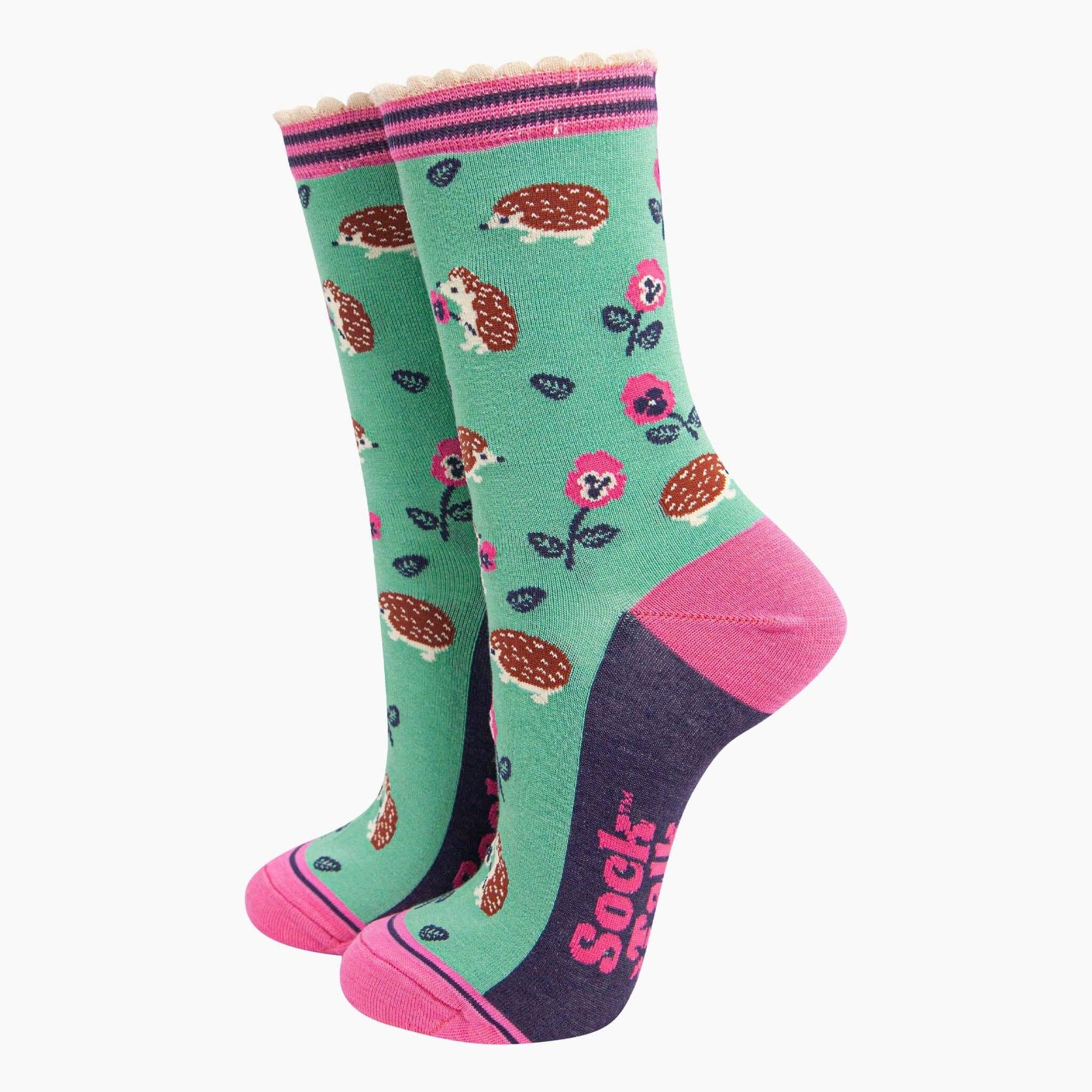 Colorful socks with hedgehog and flower pattern on a white background