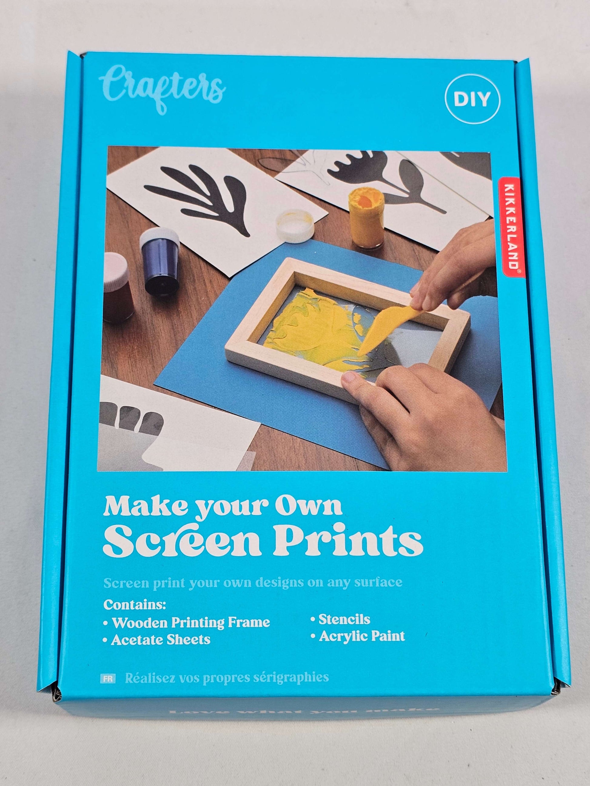 Crafters DIY screen print kit packaging with colorful designs and instructions for creating custom prints.