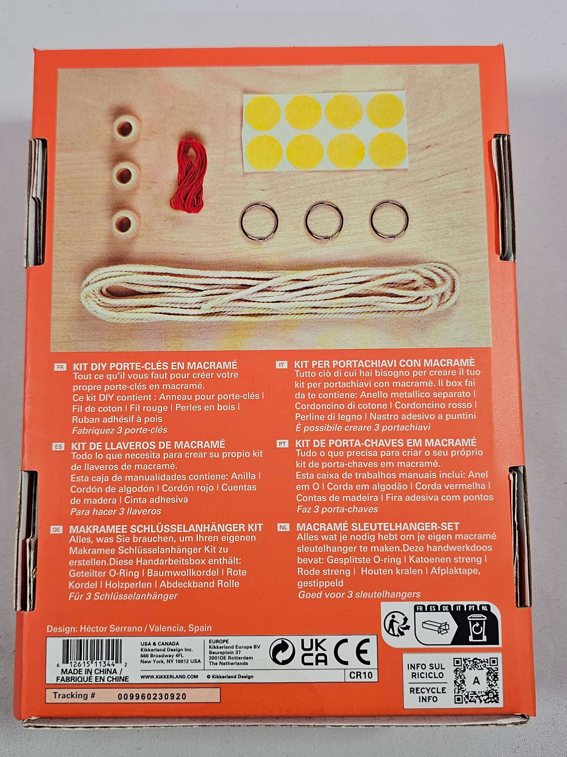 Macrame keyring kit contents including cotton cord, wooden beads, split o-rings, and masking tape dots for crafting.