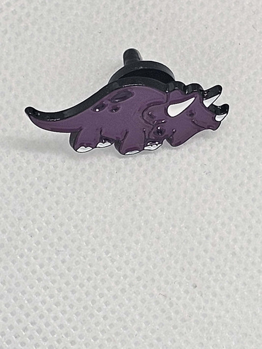 Purple triceratops enamel pin badge, perfect for dinosaur lovers as a bag or clothing accessory.