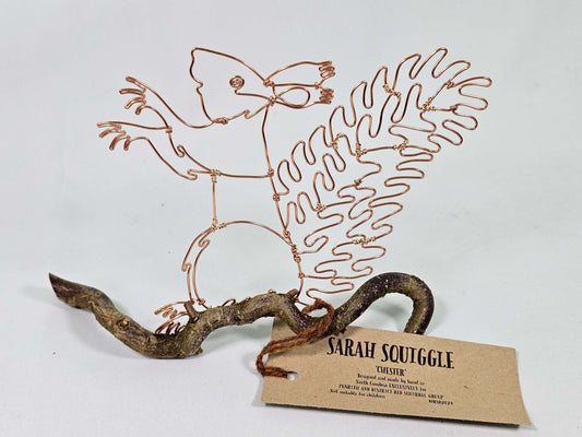 Wire sculpture of a Squirrel and branch with 'Sarah Squiggle' tag on a white background