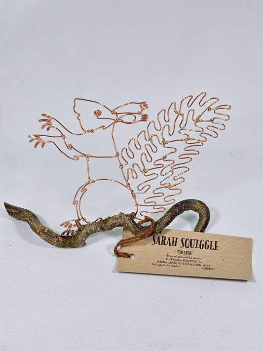 Decorative wall art with wire sculpture of a Squirrel, attached to a white background with a tag.