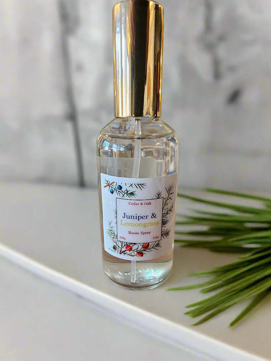 Bottle of room spray on a wooden surface with a store in the background