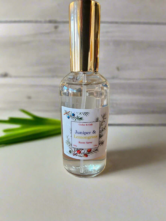 Bottle of room spray on a wooden surface with a store in the background