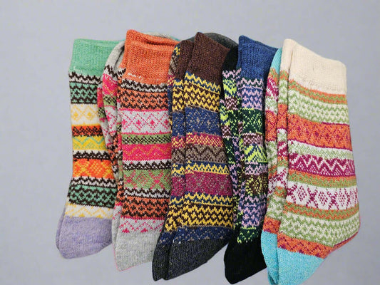 Colorful patterned socks arranged on a white surface