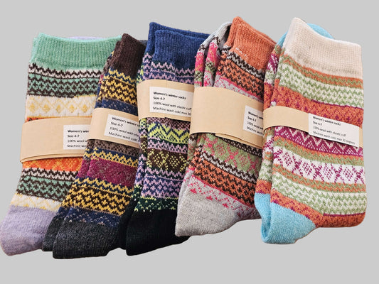 Set of colorful patterned socks on a wooden surface