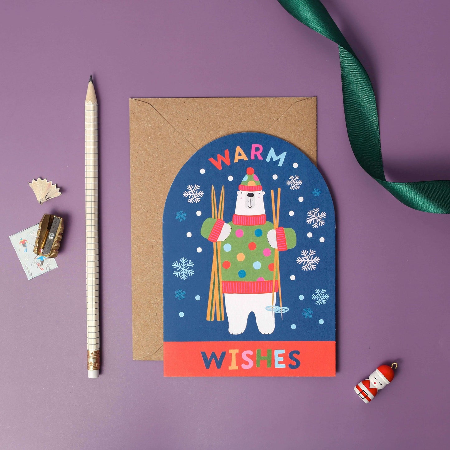 Greeting card with a polar bear illustration and 'Warm Wishes' text on a purple background.