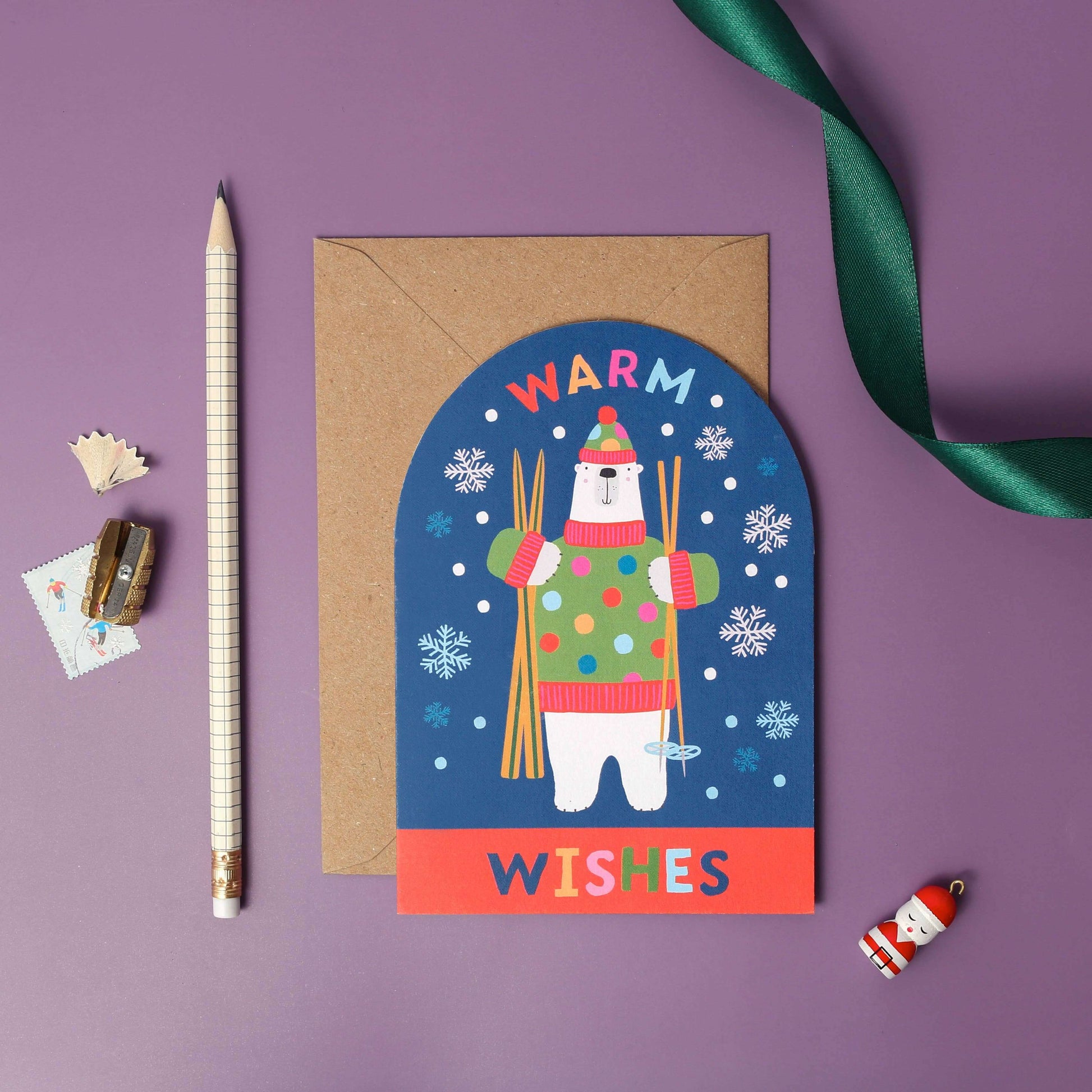 Greeting card with a polar bear illustration and 'Warm Wishes' text on a purple background.