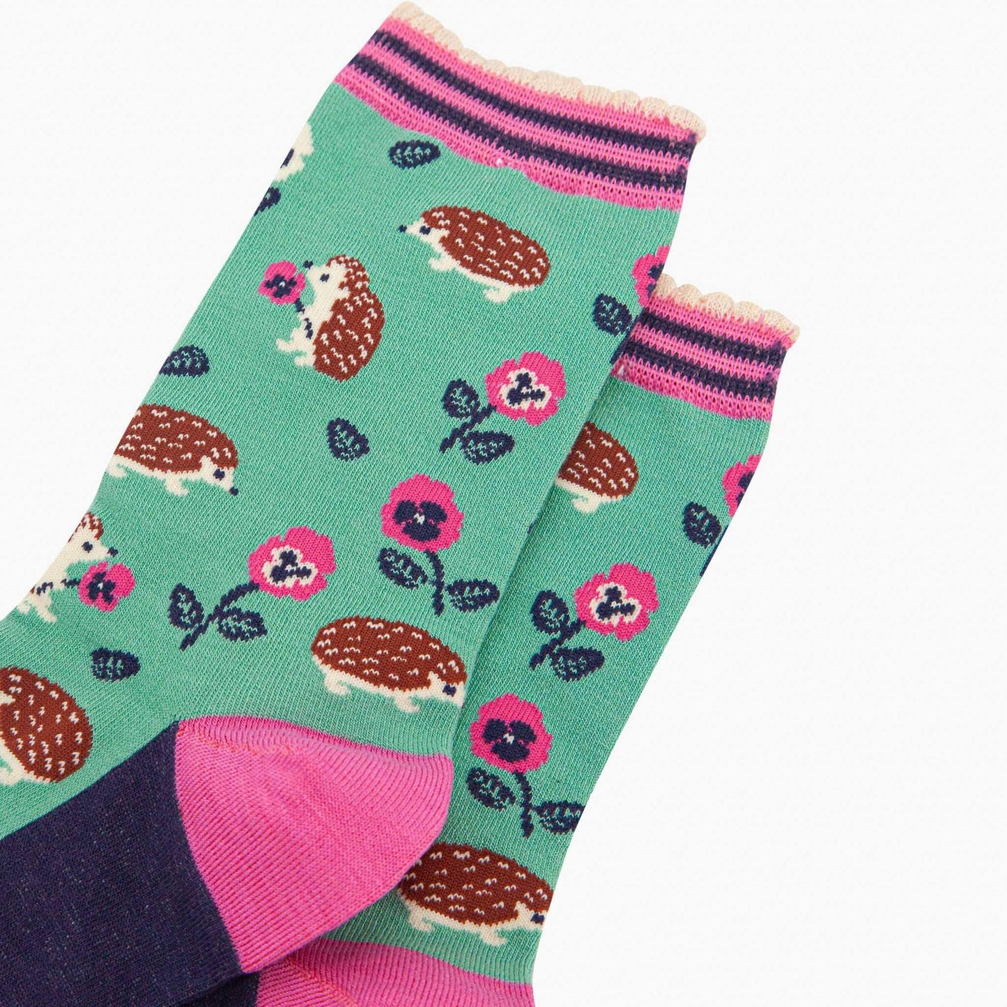 Colorful socks with hedgehog and flower pattern on a white background
