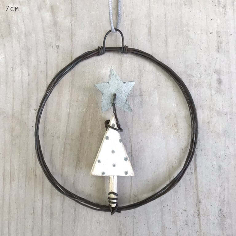 Decorative metal tree and star ornament on a wooden background