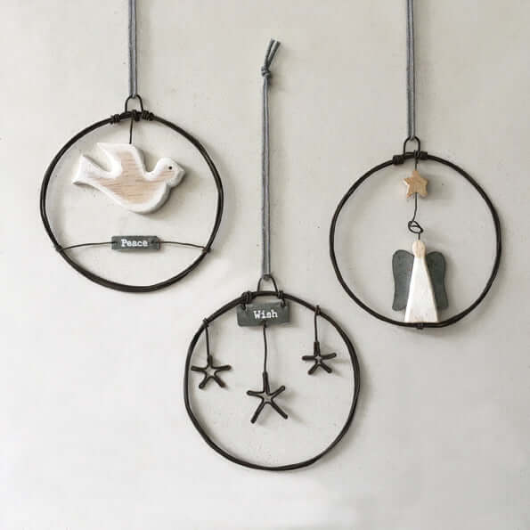 Three decorative hanging items with birds and stars on a plain background