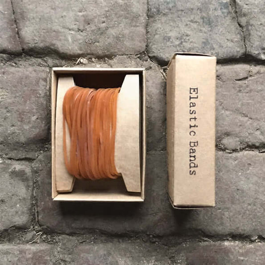 Box of elastic bands on a stone surface