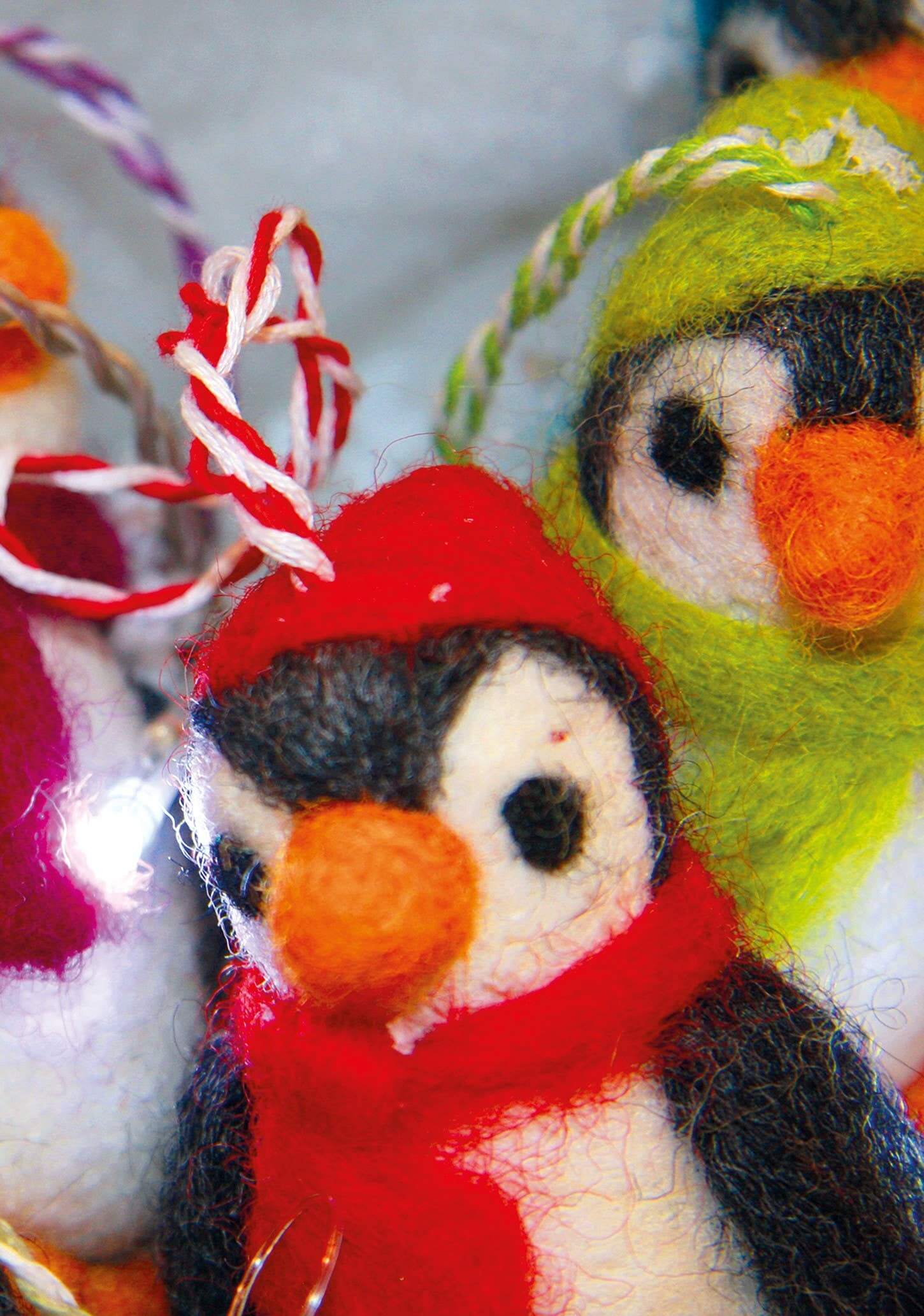 Felt Penguin Christmas Decoration featuring colorful handmade felt penguins in festive hats.