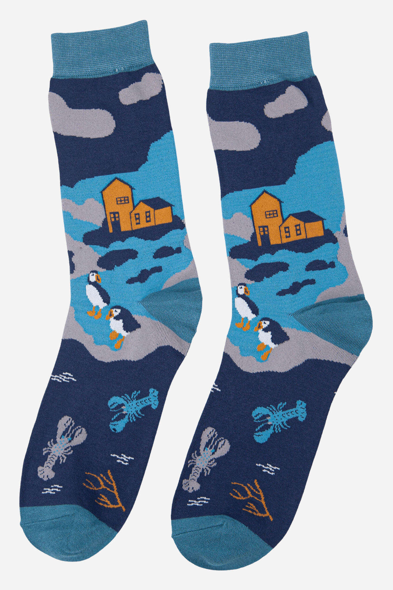 Pair of socks with puffin and house design on a blue background