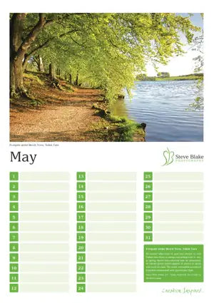 Calendar page for May with a scenic landscape of a lake and trees.