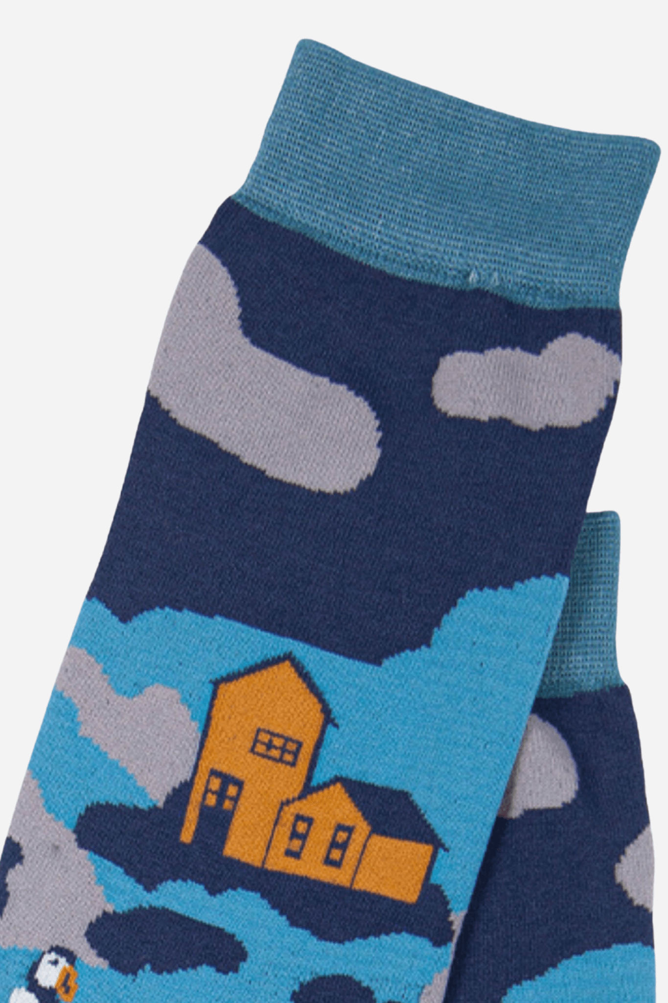 Sock with a house and cloud design on a blue background