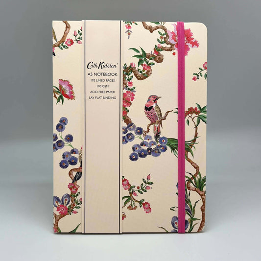 Notebook with floral and bird design on a gray background