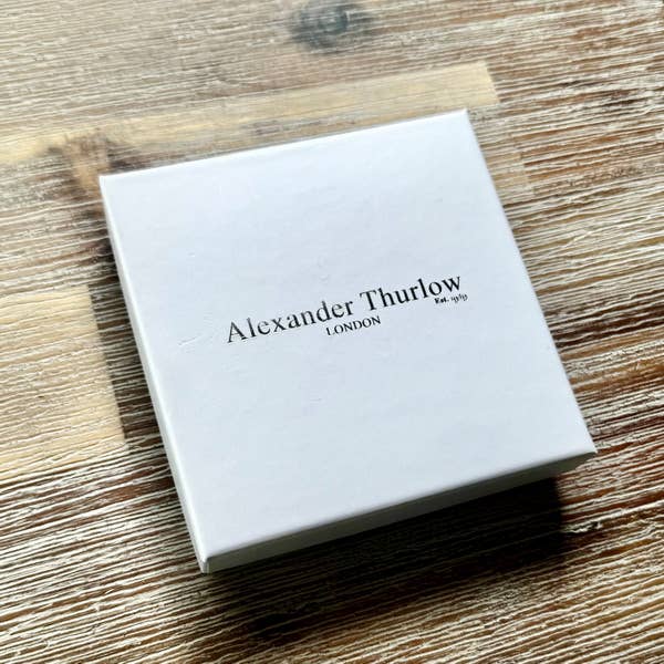 White box with 'Alexander Thurlow London' branding on a wooden surface