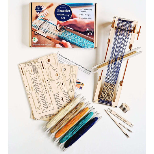 Colorful bracelet weaving kit with wooden loom, yarn, and patterning combs for creative projects.