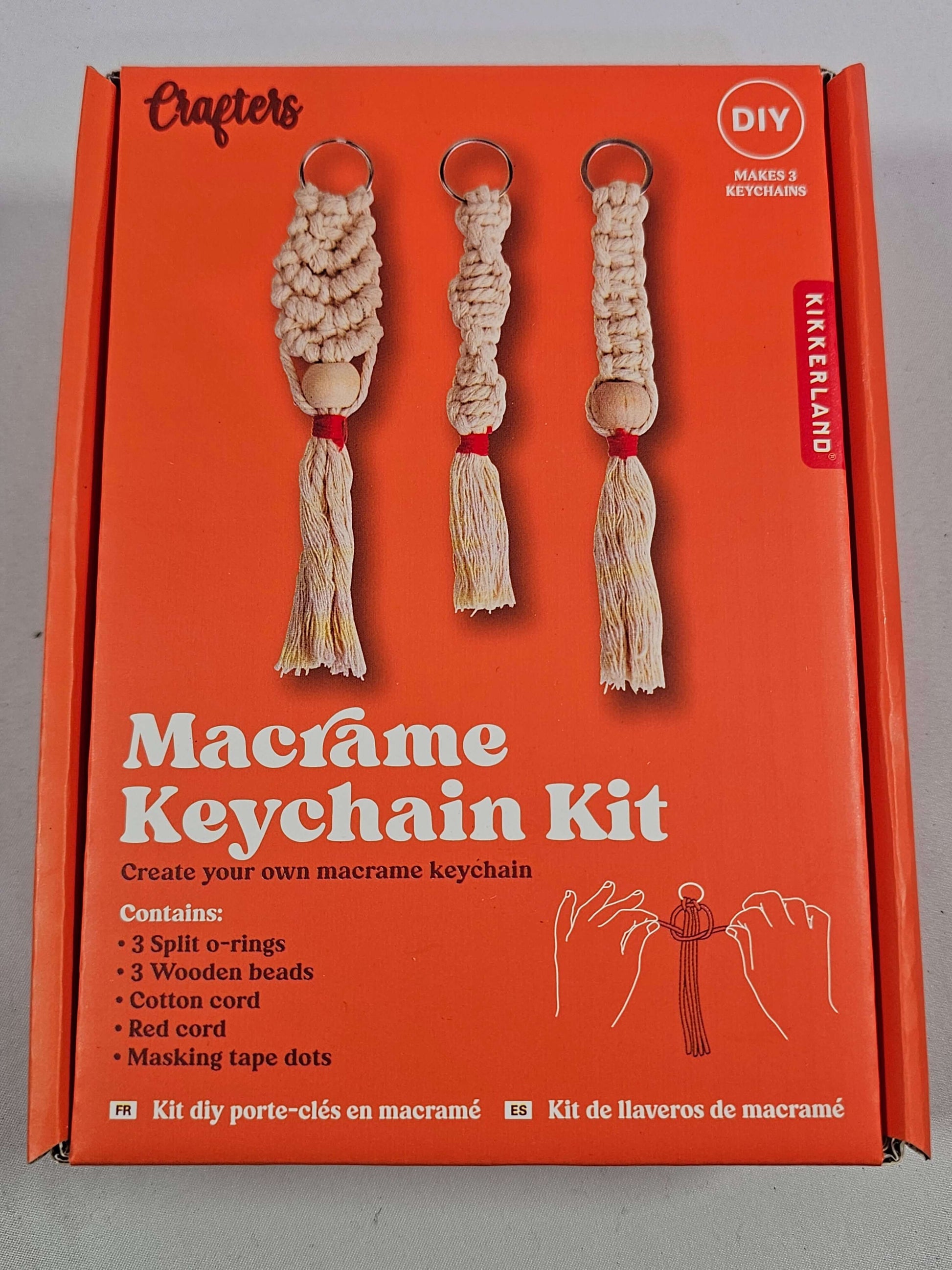DIY Macrame Keychain Kit by Kikkerland, includes supplies for three unique keyrings with cotton cord and wooden beads.