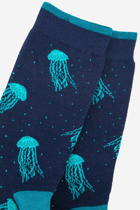 Navy socks with teal jellyfish pattern on a light gray background