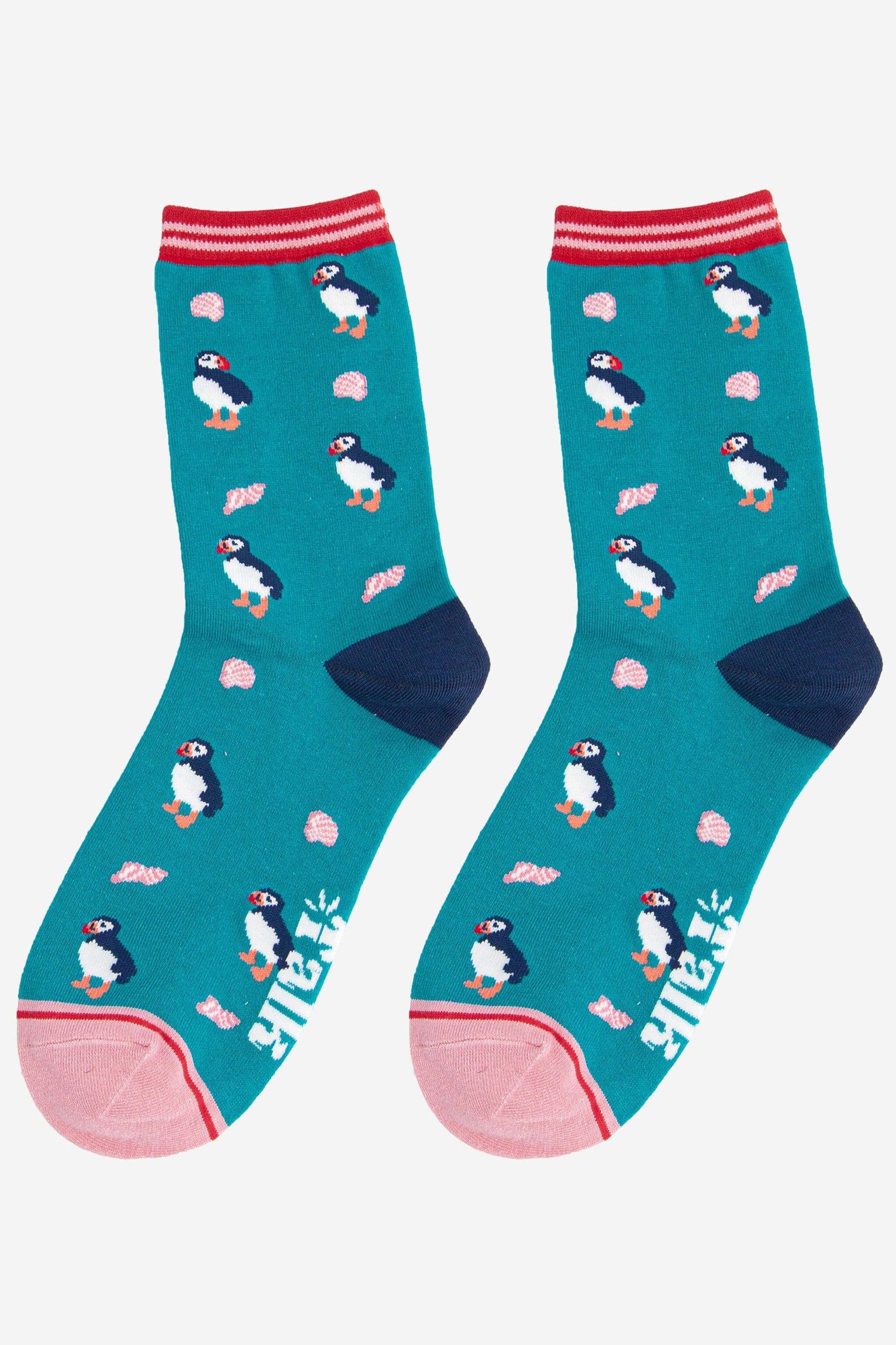 Teal socks with penguin design on a white background