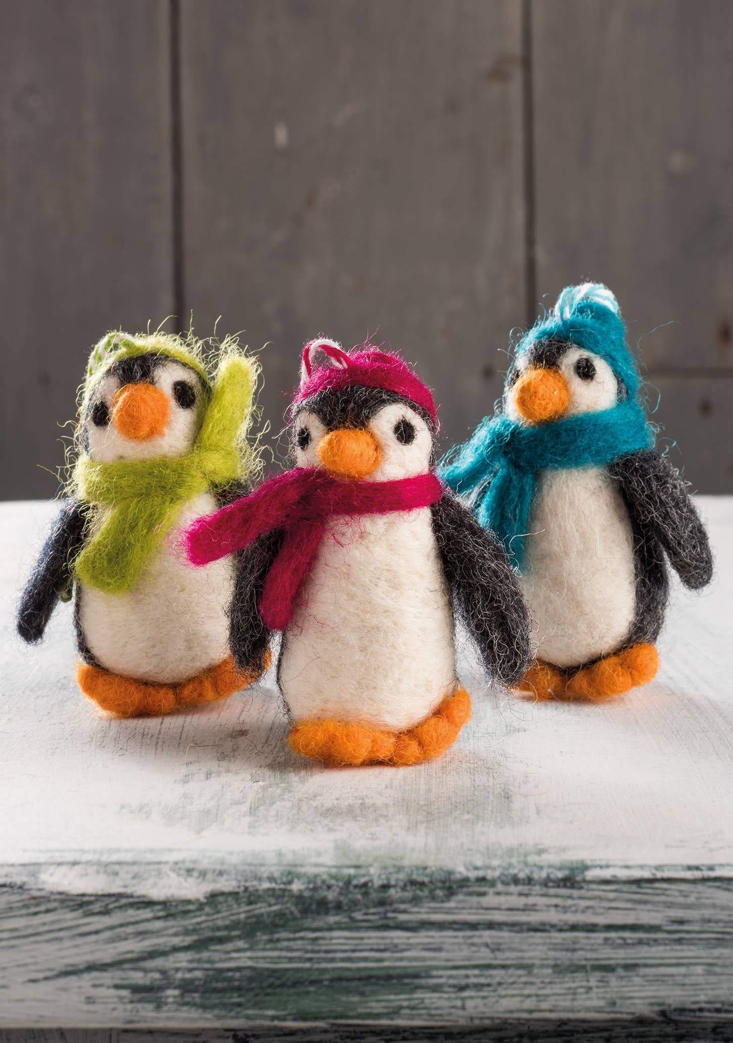 Felt Penguin Christmas Decoration featuring three colorful handmade penguins with scarves, perfect for holiday cheer.