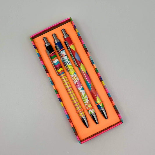 Set of pens with colorful designs in an orange box on a gray background