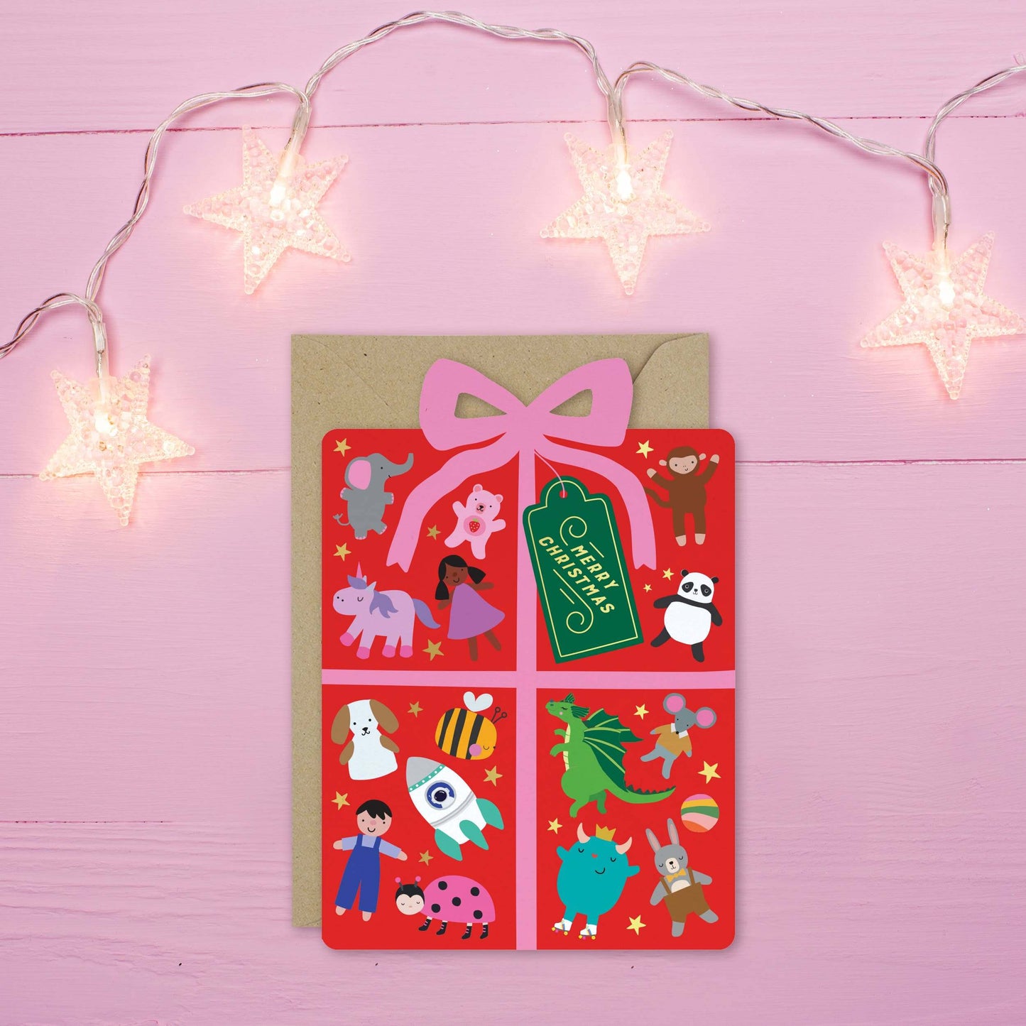 Notebook with cartoon animal illustrations on a pink background with string lights