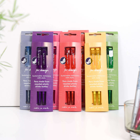 Colorful recycled pen sets in packaging, sustainable stationery made from recycled plastics, eco-friendly writing supplies.