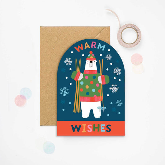 Greeting card with a polar bear illustration and 'Warm Wishes' text on a blue background.