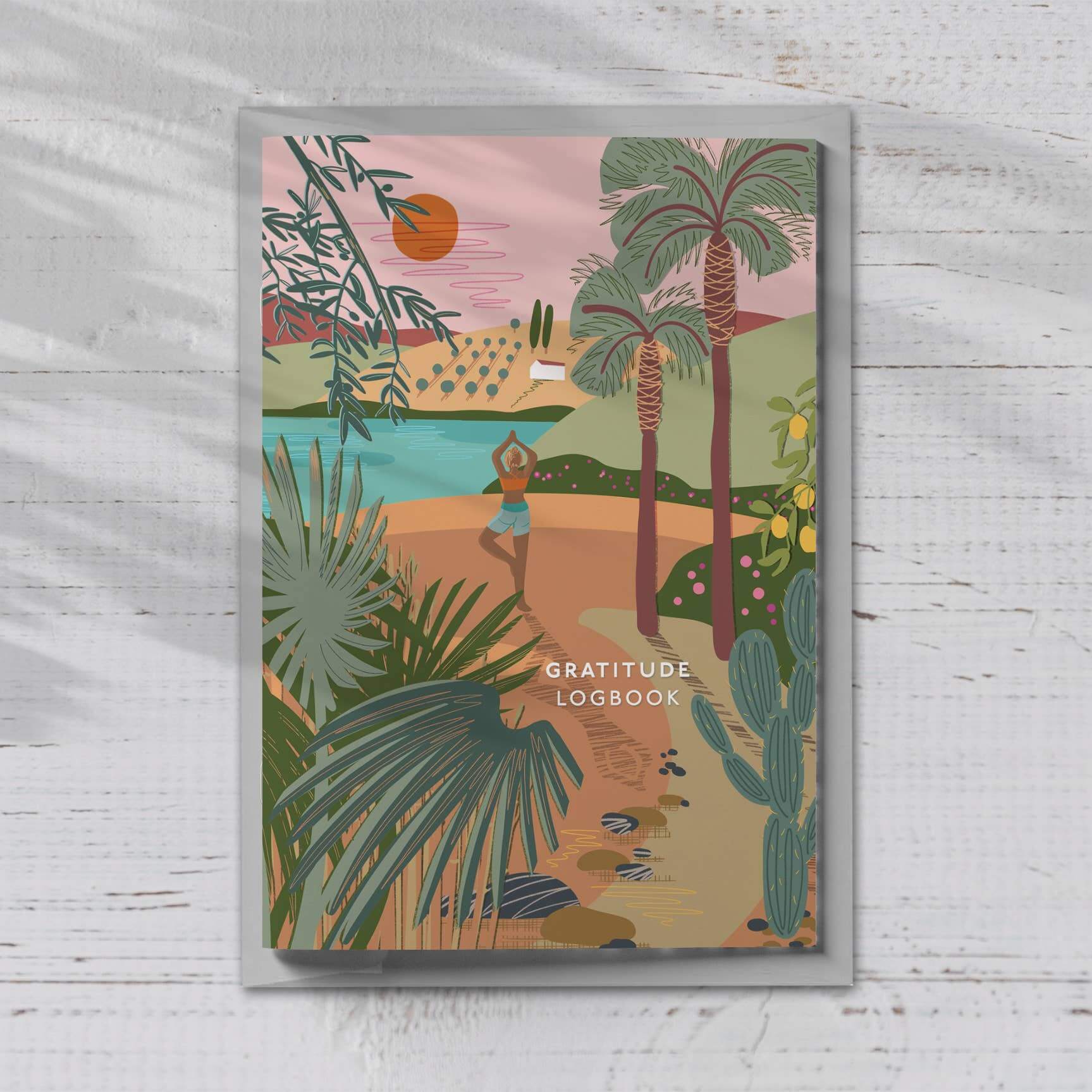 Gratitude logbook A5 with yoga-themed cover illustration, featuring vibrant nature scene and calming elements.