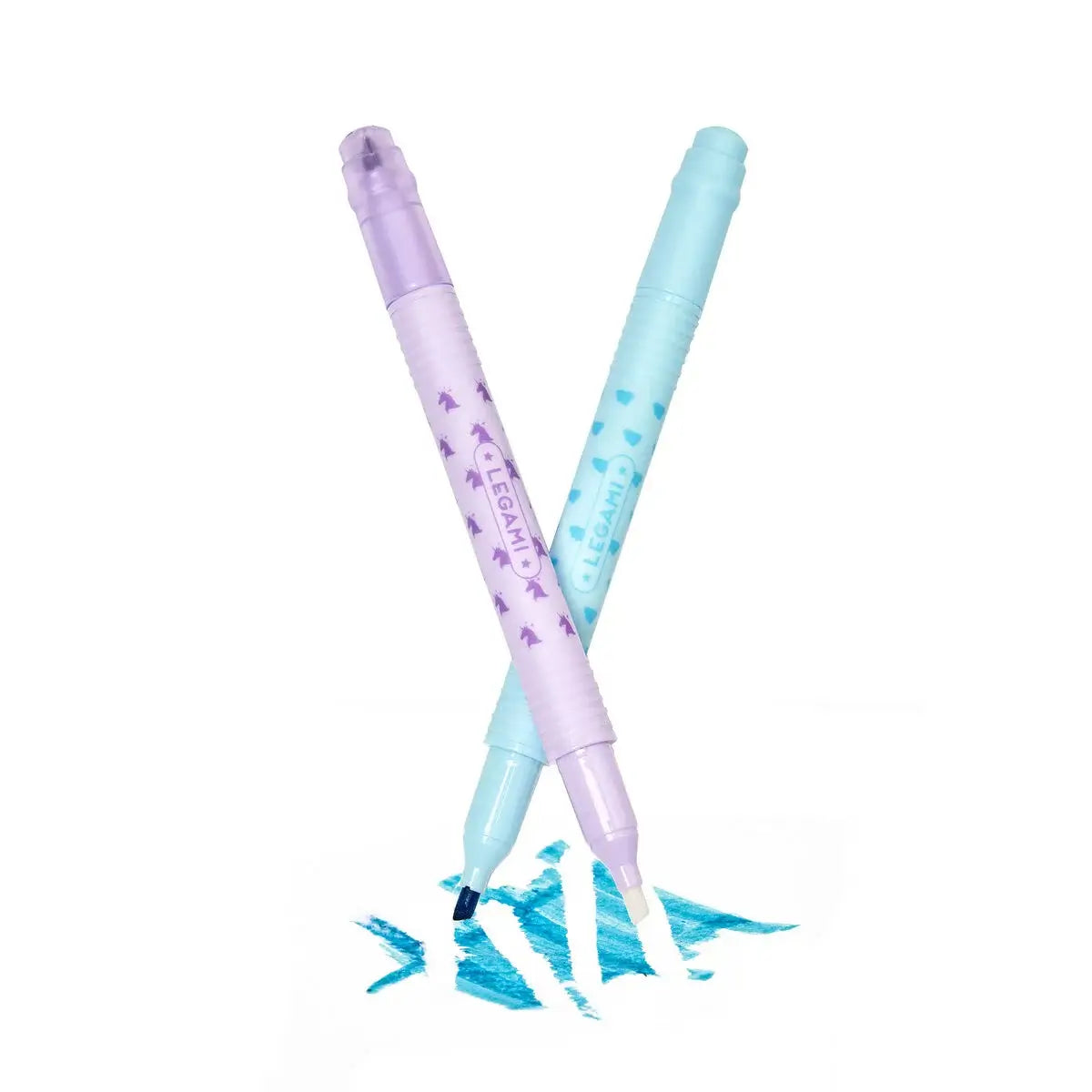 Two pastel-colored pens with blue ink splashes on a white background