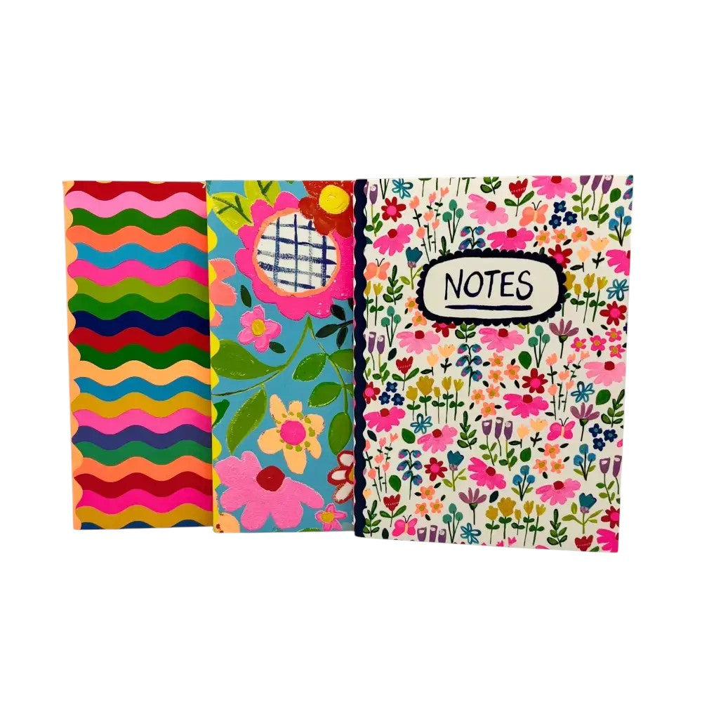 Colorful stationery notebook with floral and striped designs, perfect for notes and creative writing.