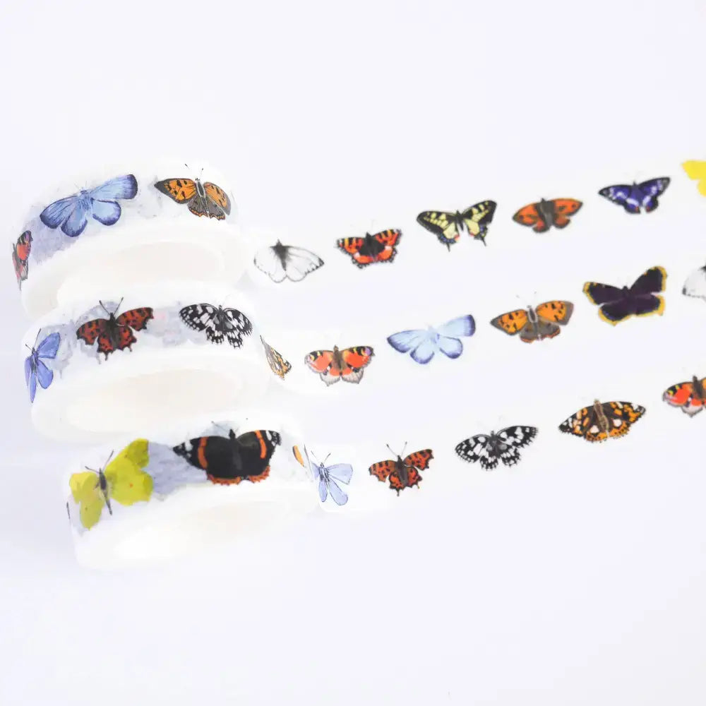 Colorful washi tape featuring various butterfly designs on a white background for craft projects.