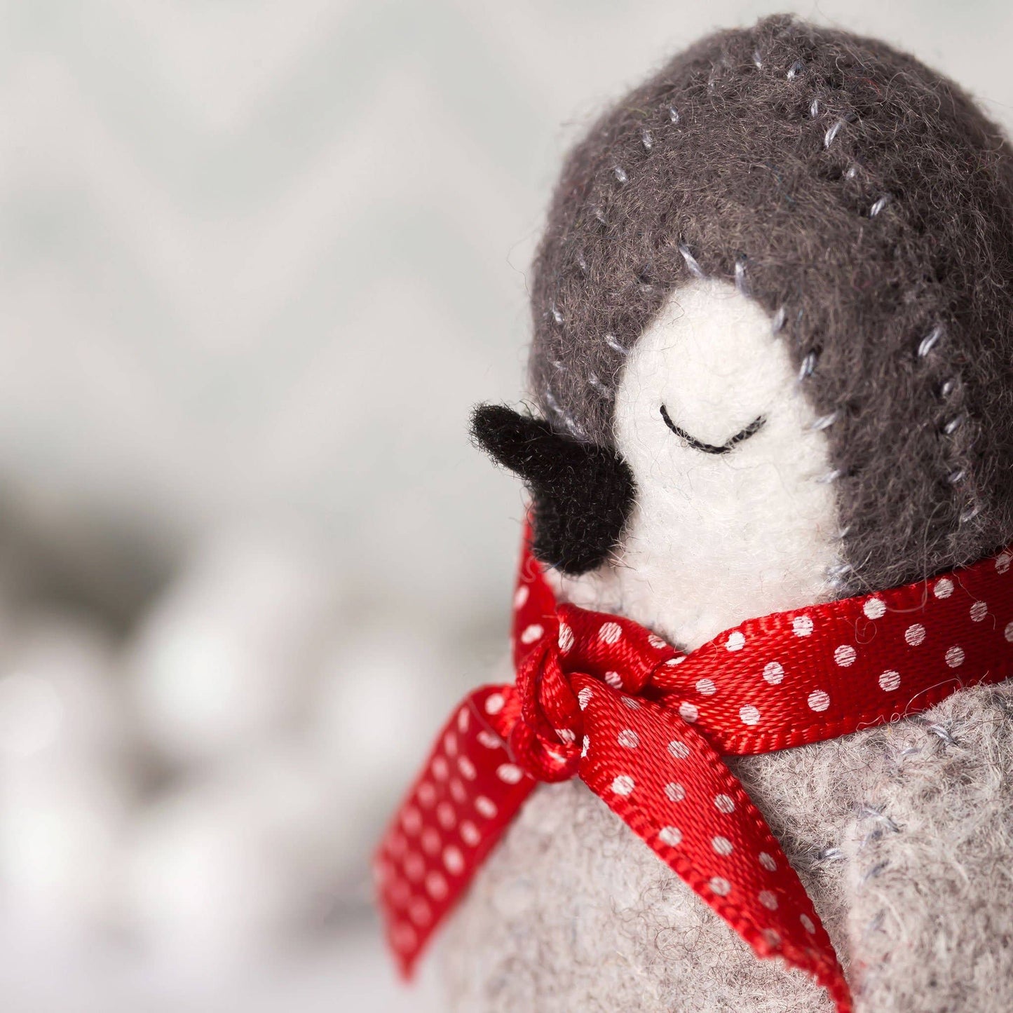 Stuffed animal with a red polka dot bow on a blurred background