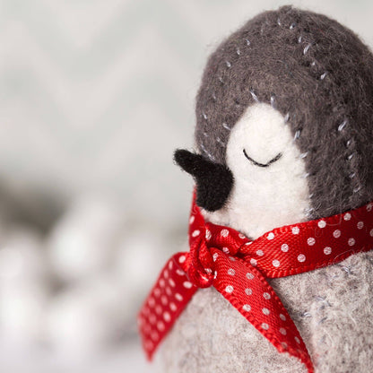 Stuffed animal with a red polka dot bow on a blurred background