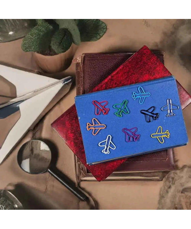 20 airplane shaped paper clips in a tin.