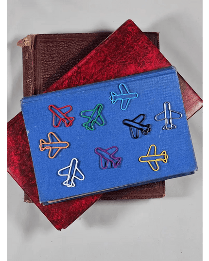 20 airplane shaped paper clips in a tin.