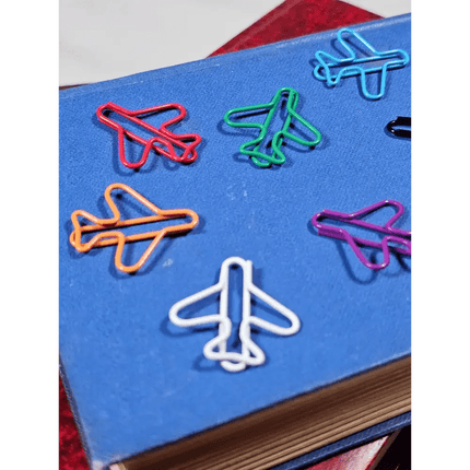 20 airplane shaped paper clips in a tin.