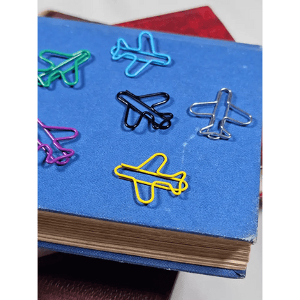 20 airplane shaped paper clips in a tin.