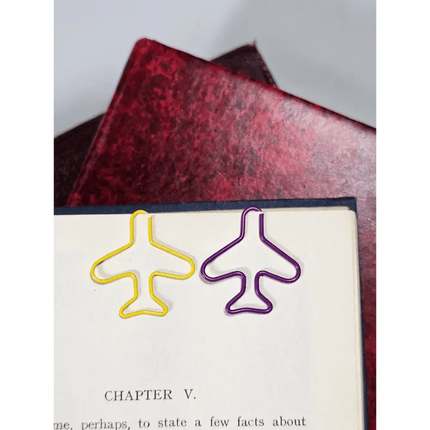 20 airplane shaped paper clips in a tin.