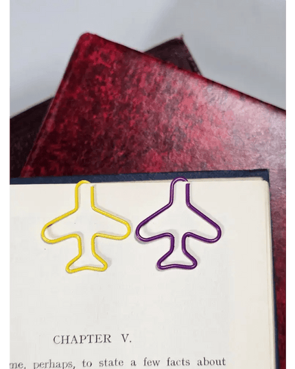 20 airplane shaped paper clips in a tin.