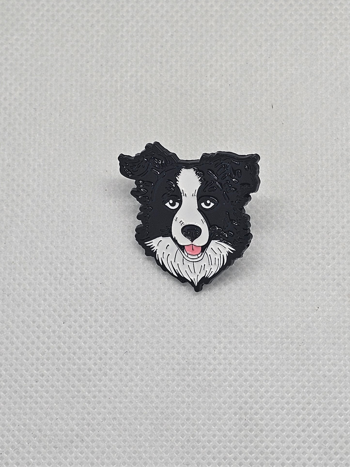 Black and white Border Collie enamel pin badge, perfect for dog lovers to accessorize clothing and bags.
