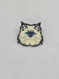 Enamel pin badge featuring a fluffy cat design with blue eyes, perfect for pet lovers.